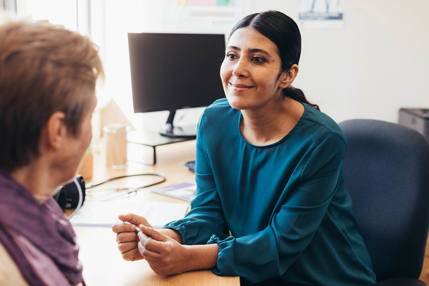 A female GP speaks with a female patient