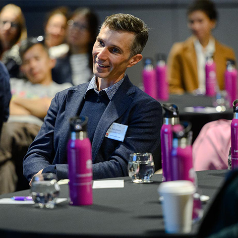 Associate Professor Ben Smith in front of BreastScreen NSW waterbottles