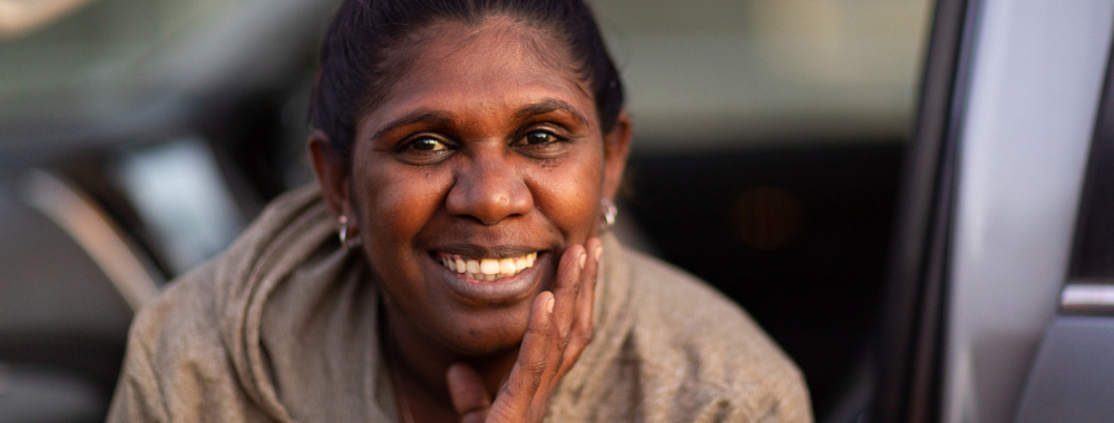 An image of a woman smiling at the camera.
