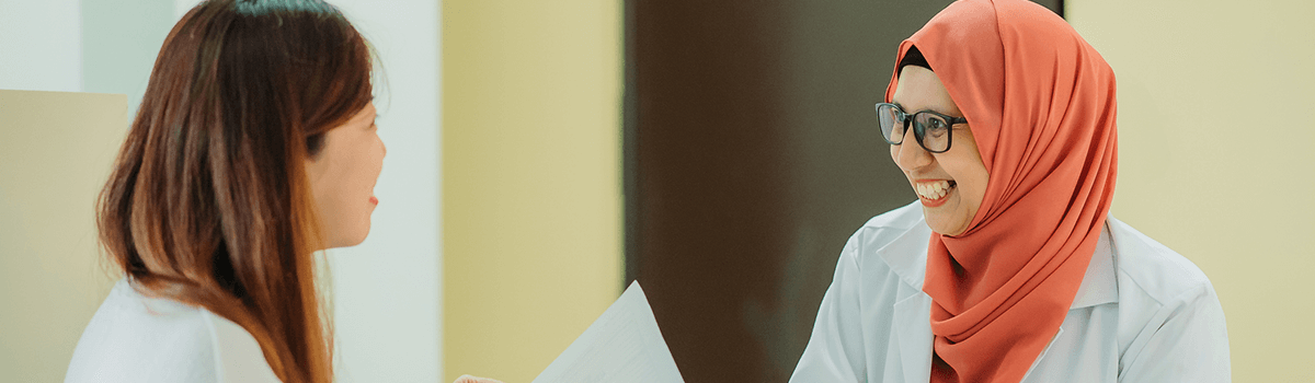 Female doctor speaking with her female patient